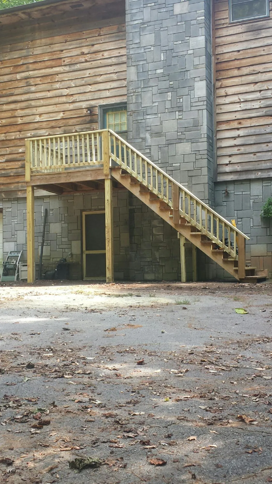 New pressure treated deck and stair landing on a log home in Nanuet
